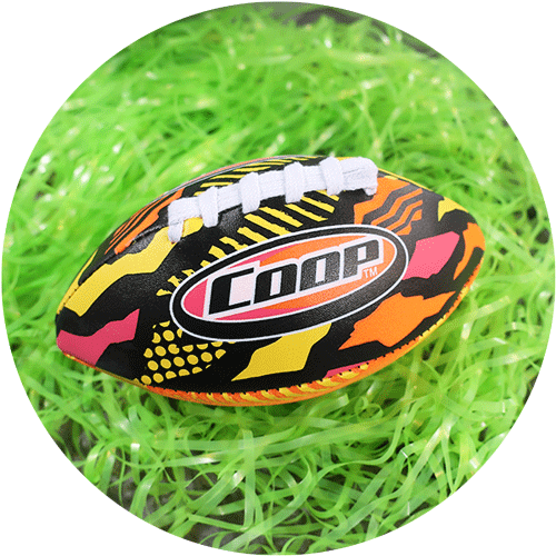 A small football with yellow, orange, red and black design, surrounded by green easter grass and colorful easter eggs.